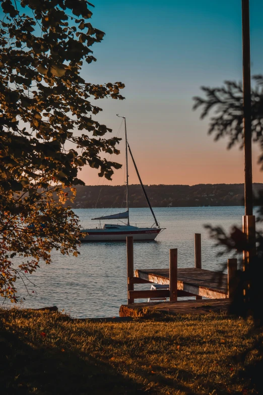 a boat sitting on the water next to a dock