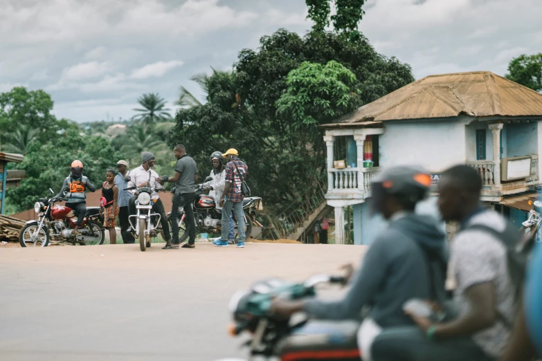 people riding motorcycles and walking down the street