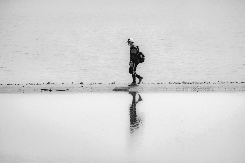 a person walking across a lake holding an umbrella