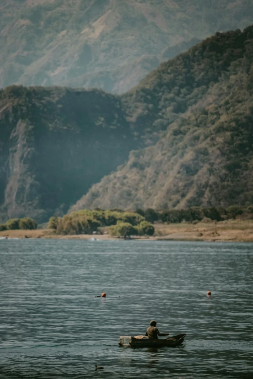 a man is in his small canoe out on the water