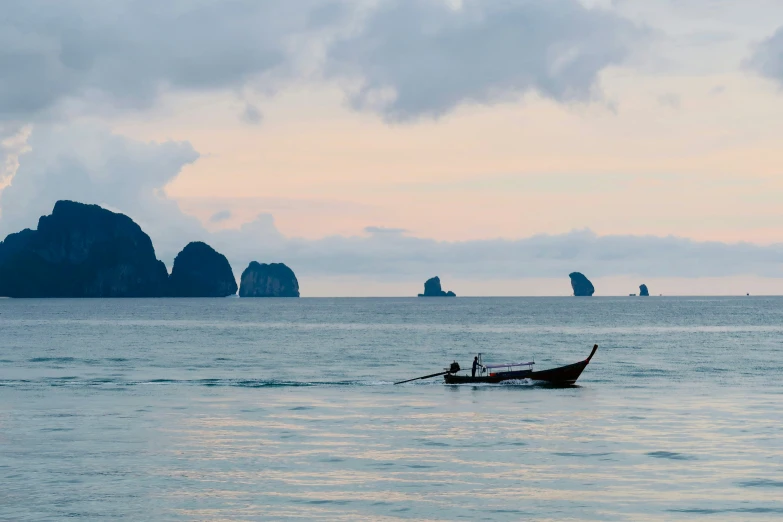 a small boat in the middle of an ocean