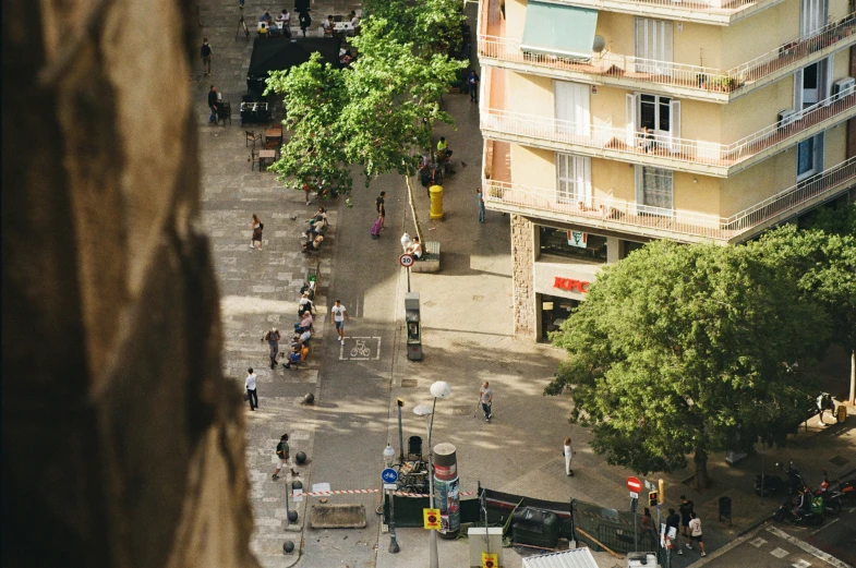 an aerial view of people walking around a city street