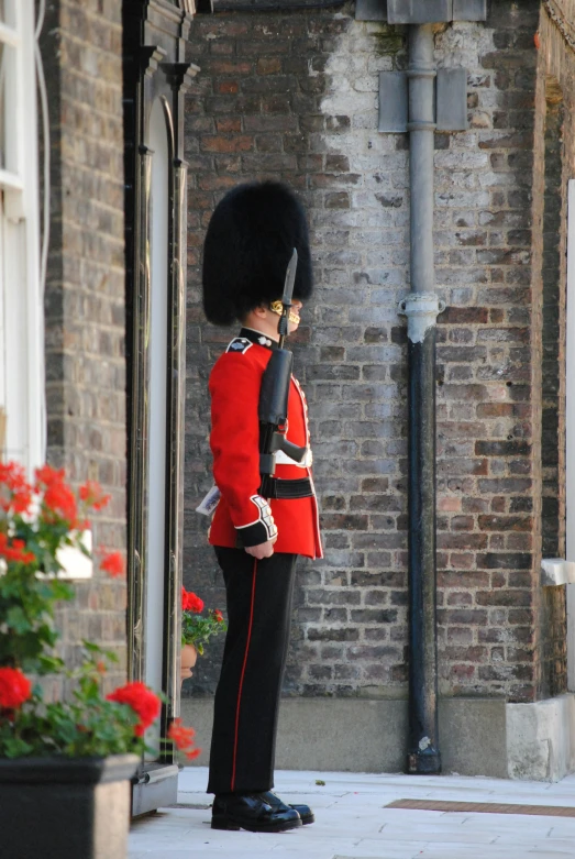 there is an guard with a large black hat on top of his head