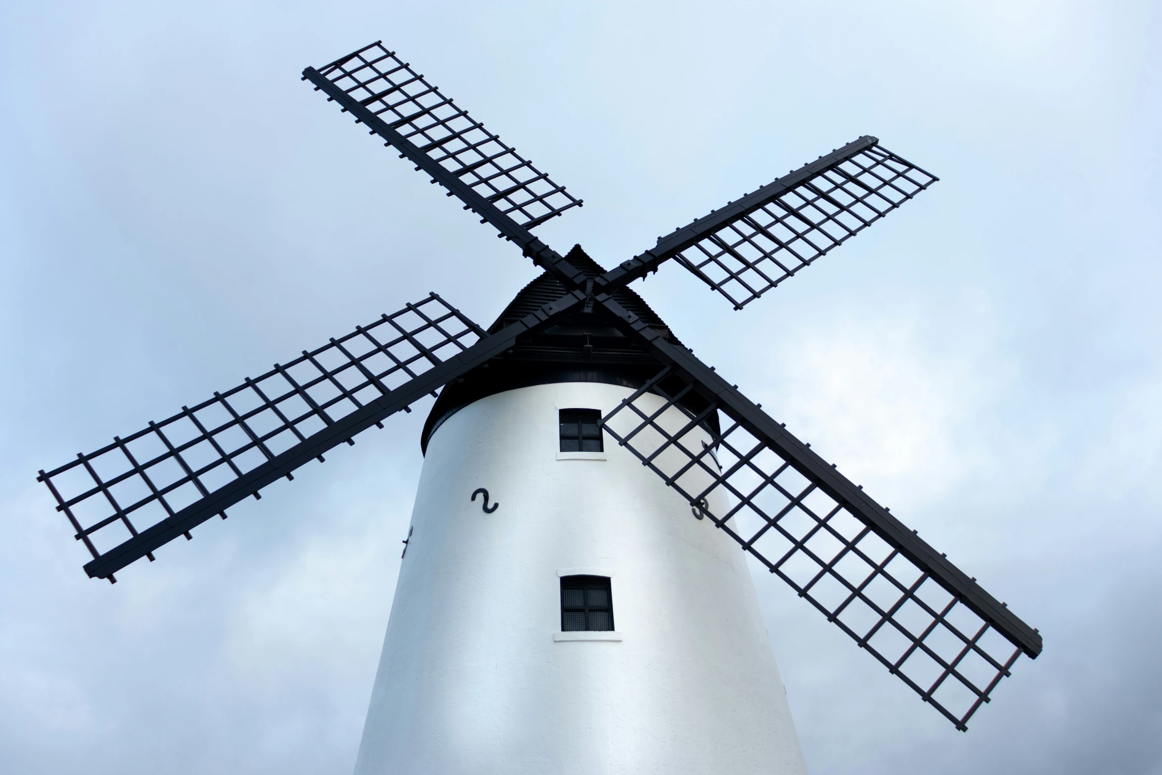 a windmill with black trim and window frames