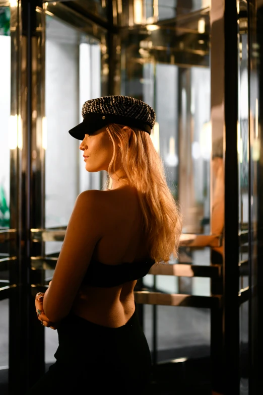 a girl in an elevator, with her hair pulled back