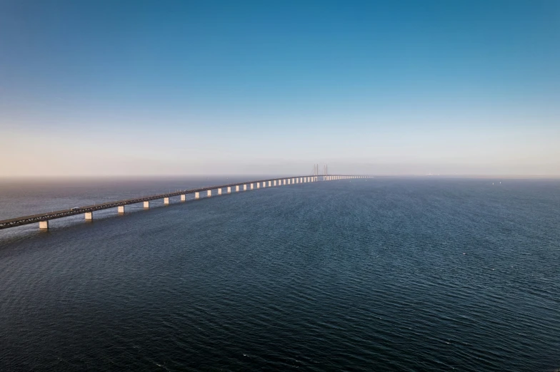 a very long bridge that is spanning over some water