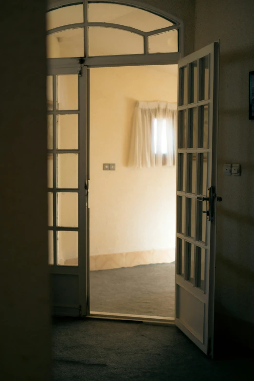 an open door on the floor looking into a bathroom