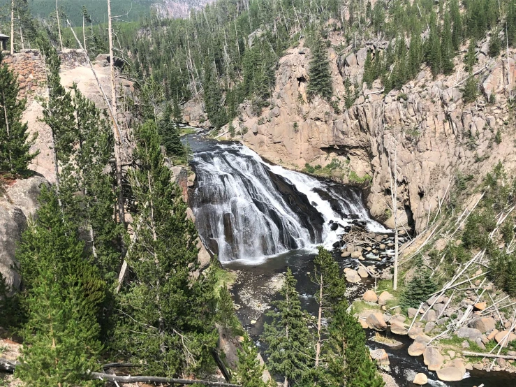 a beautiful waterfall on the side of a hill