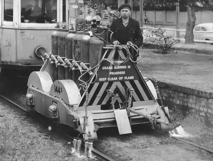 a man standing next to a train on tracks