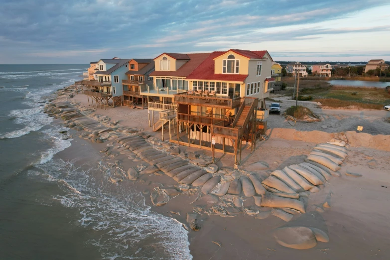 a house with a lot of windows on the beach