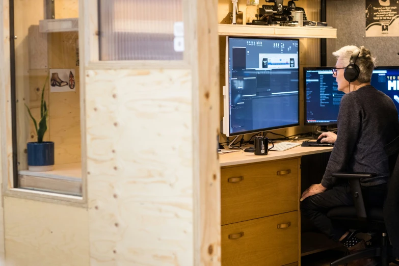 two men are working on a computer together