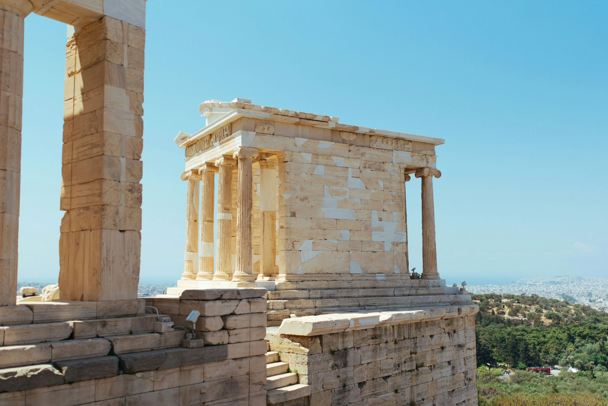 an ancient greek temple stands on top of a hill