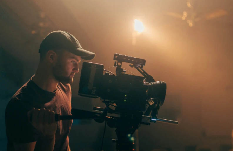 a man is filming with the camera at night