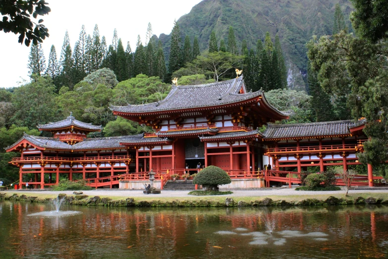 a red building in front of a small lake