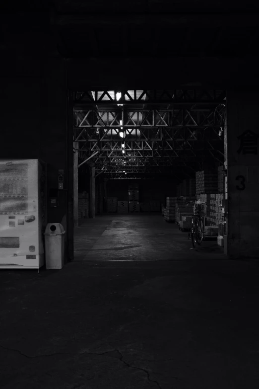 an empty tunnel in the dark and the ceiling is covered with metal