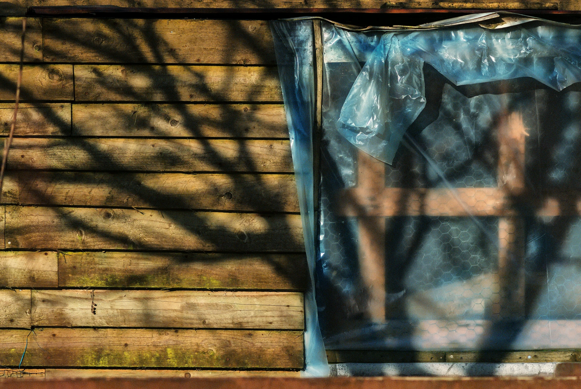 a reflection of a blue cloth covering a window