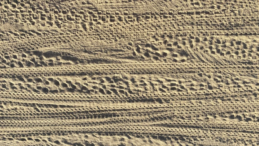 sand textured in close up on top of the camera