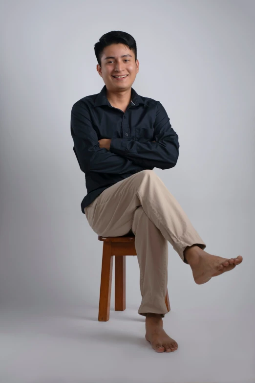 a man is sitting on top of a stool