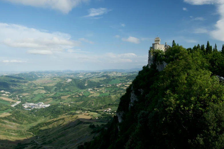 a white and grey castle on top of a mountain