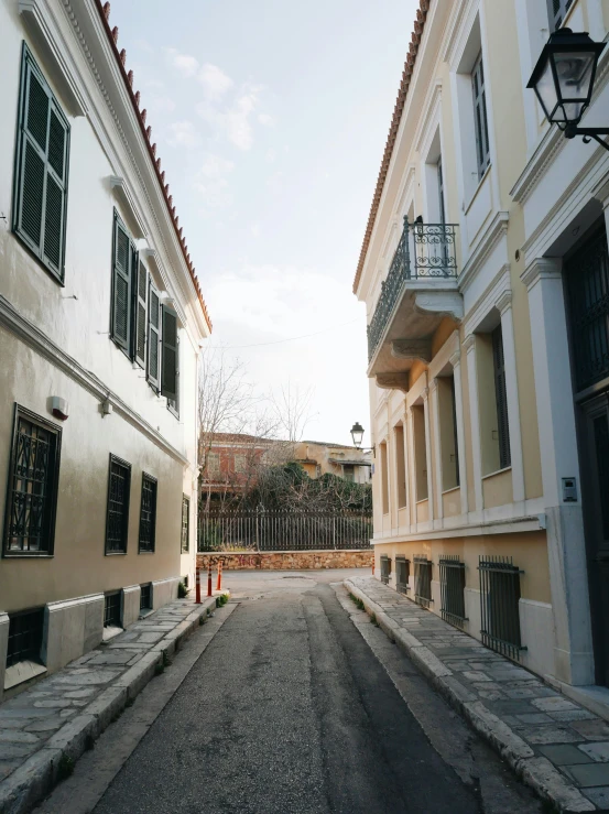 a street is lined with buildings and lamp posts