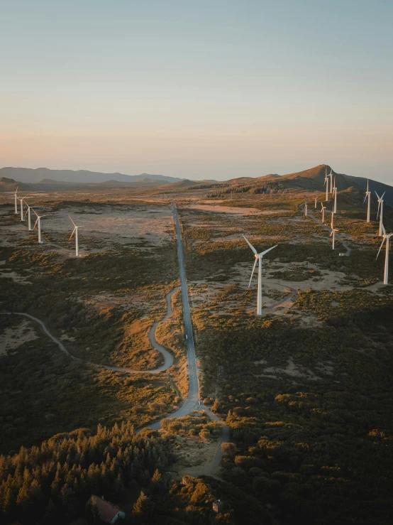 aerial view of wind mills on an arid field