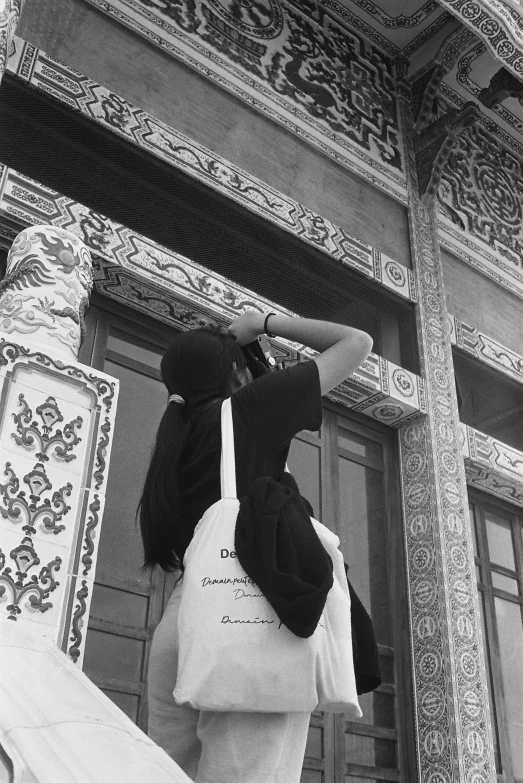 a woman carrying a large bag up a staircase