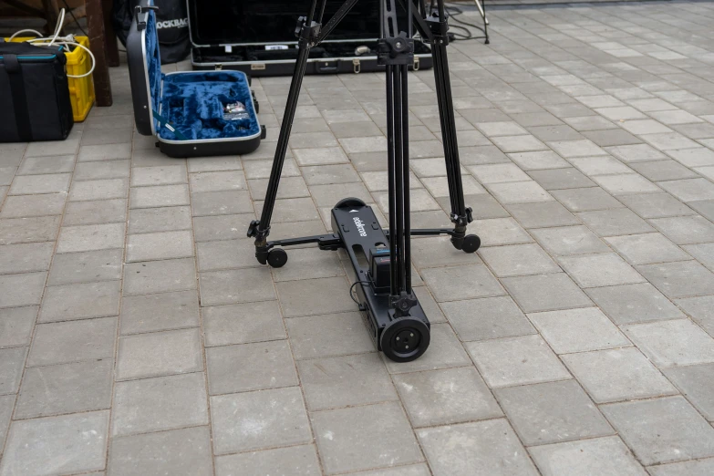 a portable tripod sitting on top of a sidewalk