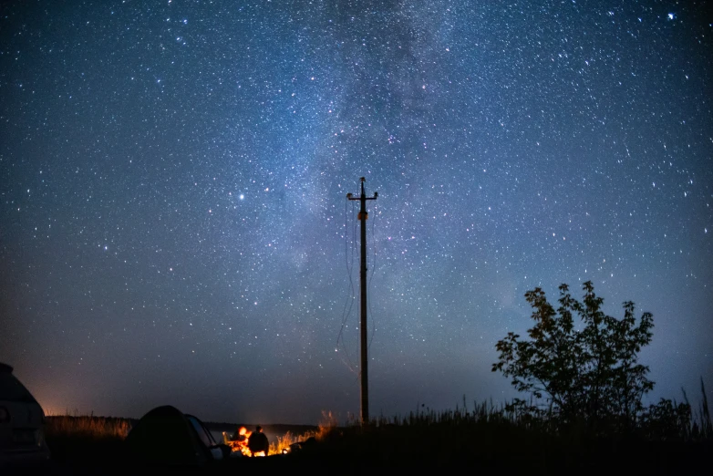 a pole under the night sky with stars