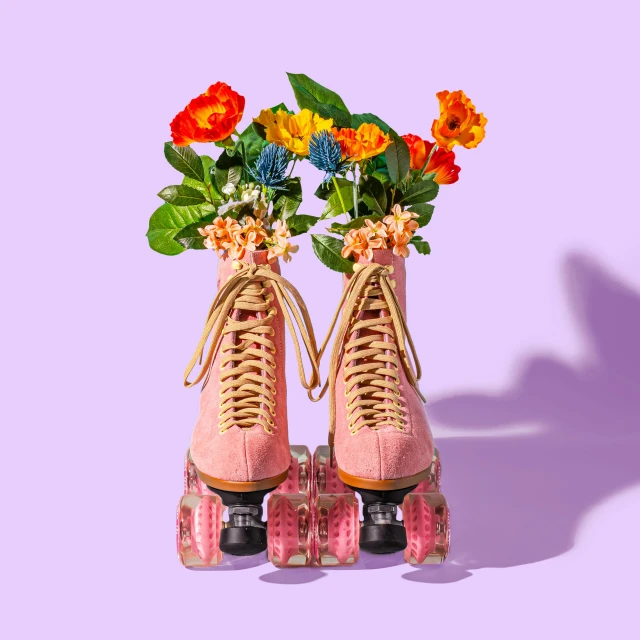 a pair of pink roller skates with flowers on them