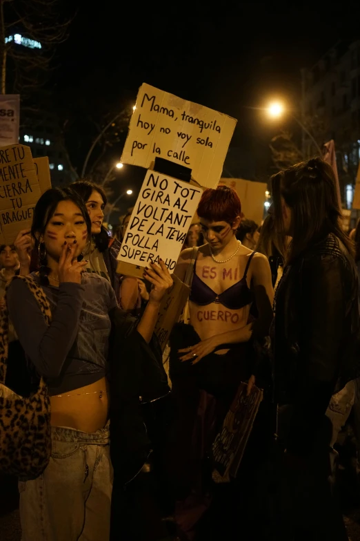 several protesters in the street holding signs