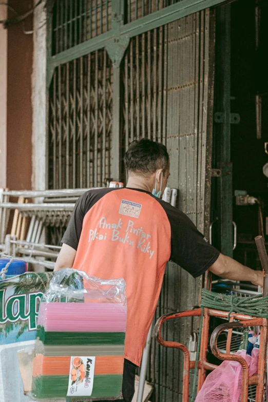 the man is in his shop looking at several items