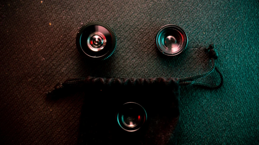 several metal bowls sitting on a cloth surface