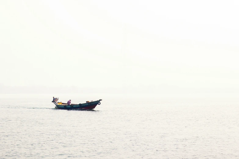 a group of people on a small boat floating on the water