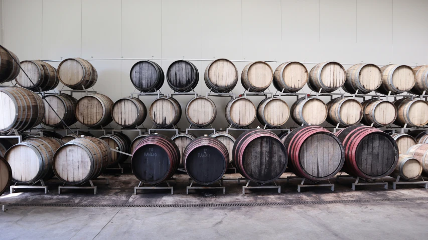 several rows of barrels are stacked near each other