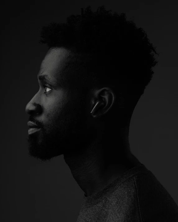 a black man with a beard in a dark background