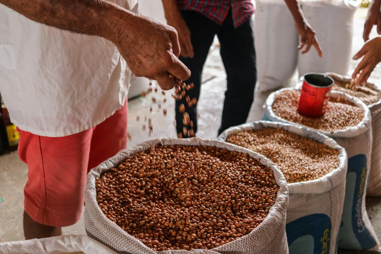 a person making food with grains on top of it