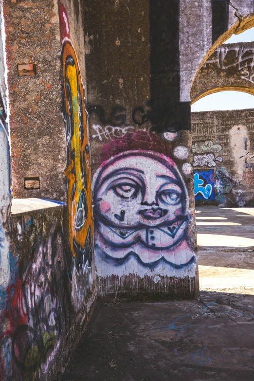 colorful paintings on a dirty building in an alleyway