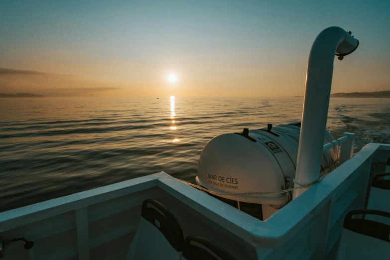 the view of the ocean from the boat during sunset