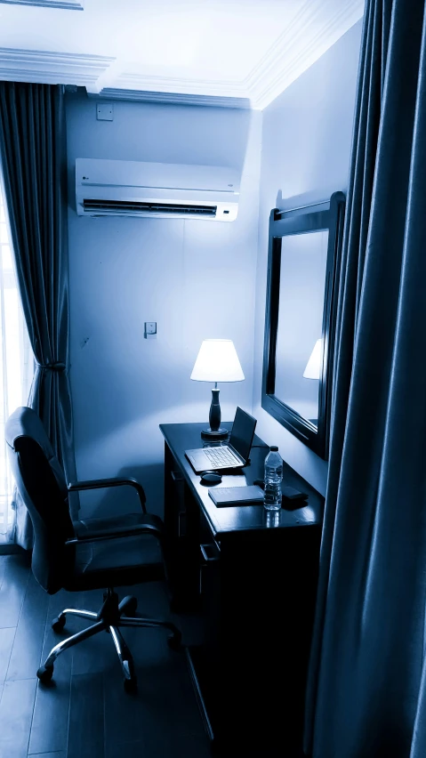 a room with desk, chair and mirror