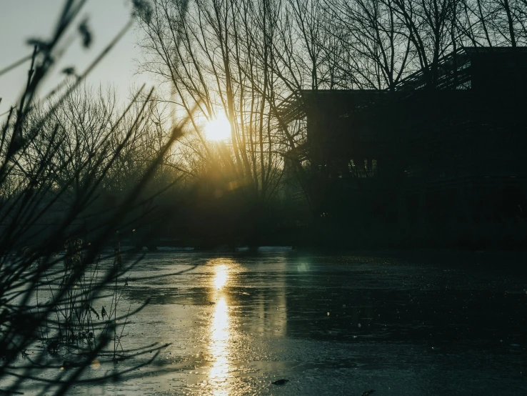 sun reflects on the water in front of an old building