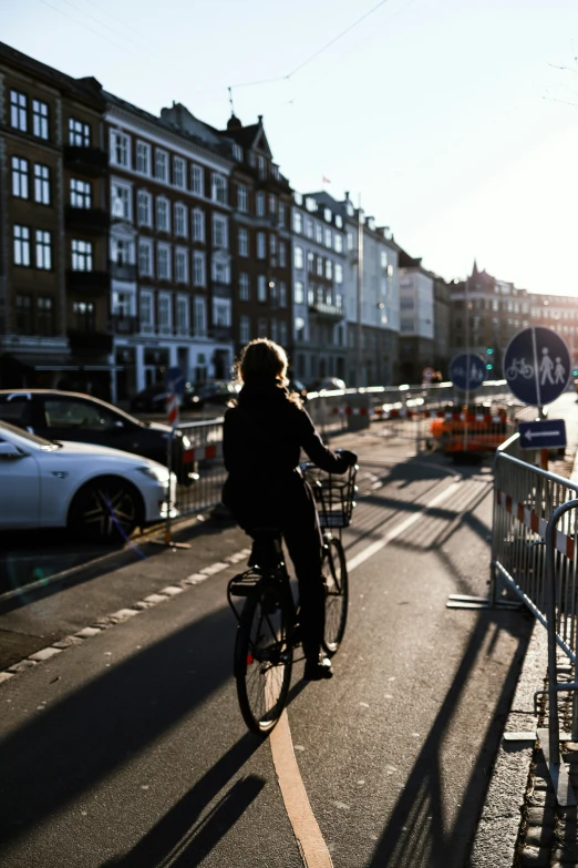 a person on a bicycle riding along a street