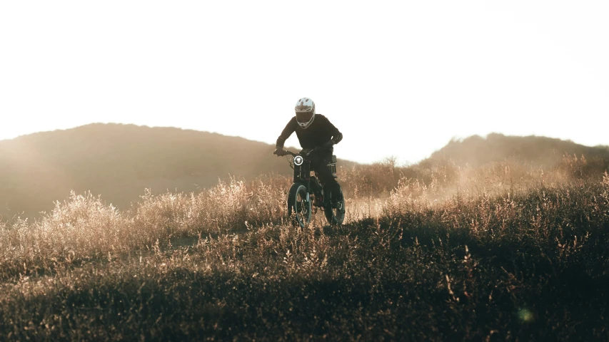 a person riding a bike on a field