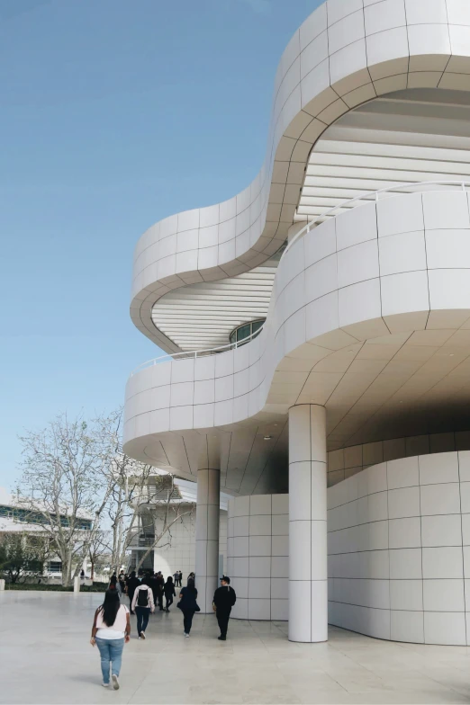 two people walking in front of a building