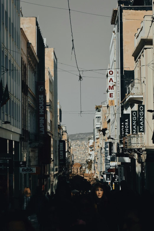 pedestrians walk by on an urban street in a city
