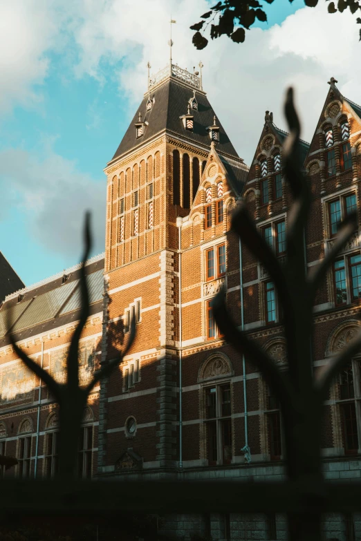 a brown building with a large tower is seen through the nches