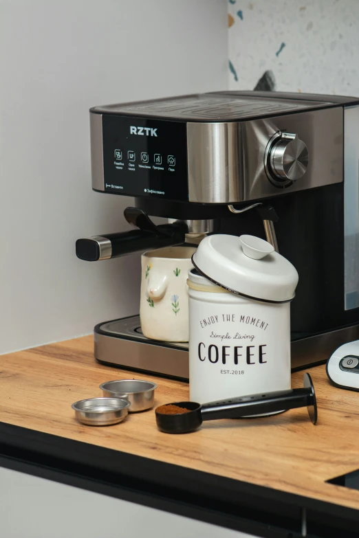 coffee maker, grinder and mugs on counter top