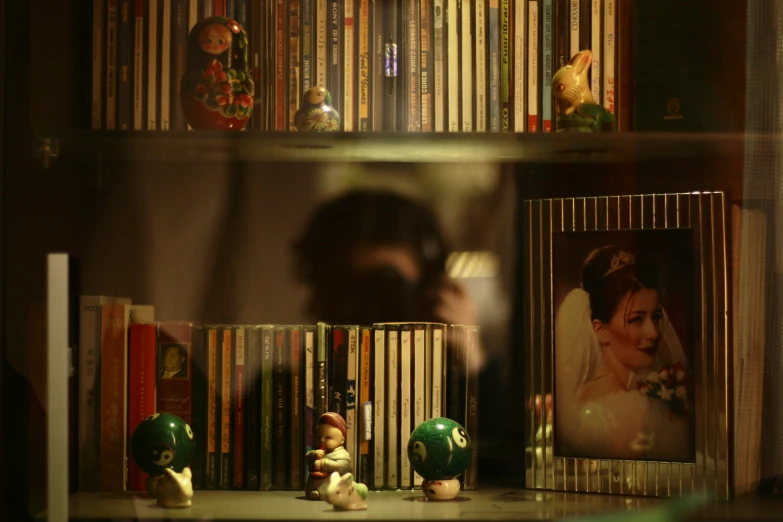 a shelf with a bride picture and two books