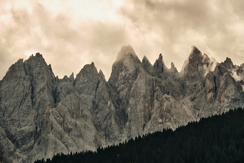 a picture of a mountain range with tall mountains in the background