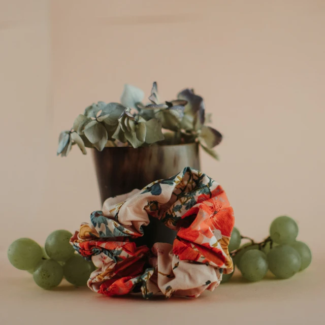 a flower pot with gs and some fabric wrapped around it