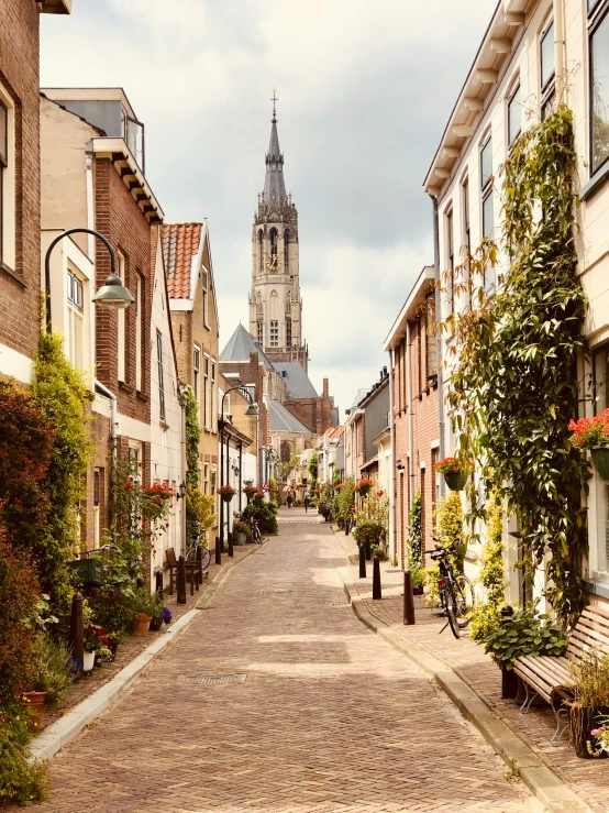 an old european city is dotted with houses and a large steeple